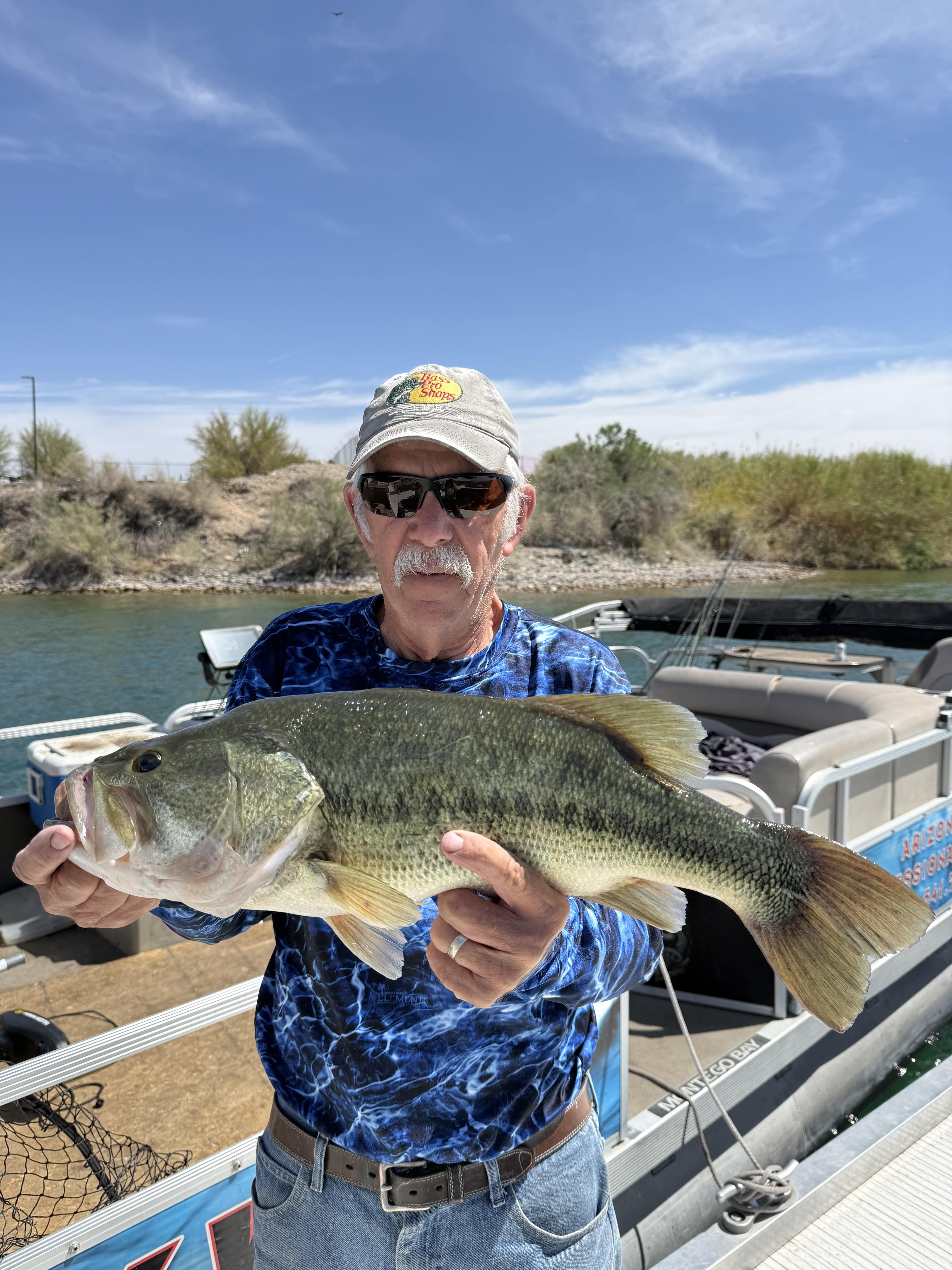 Angler holding a largemouth bass on Lake Havasu