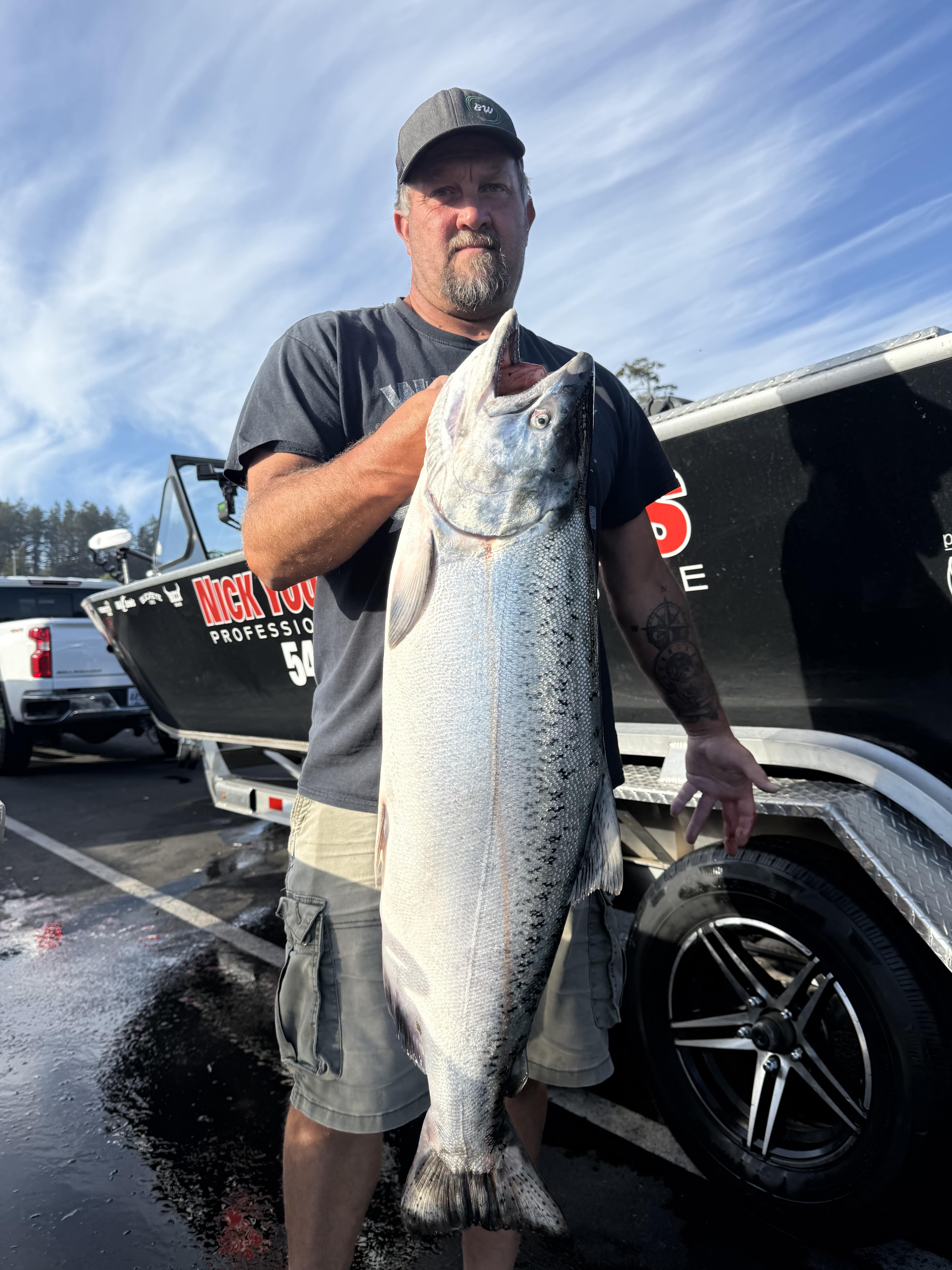Angler posing with a striped bass near the marina