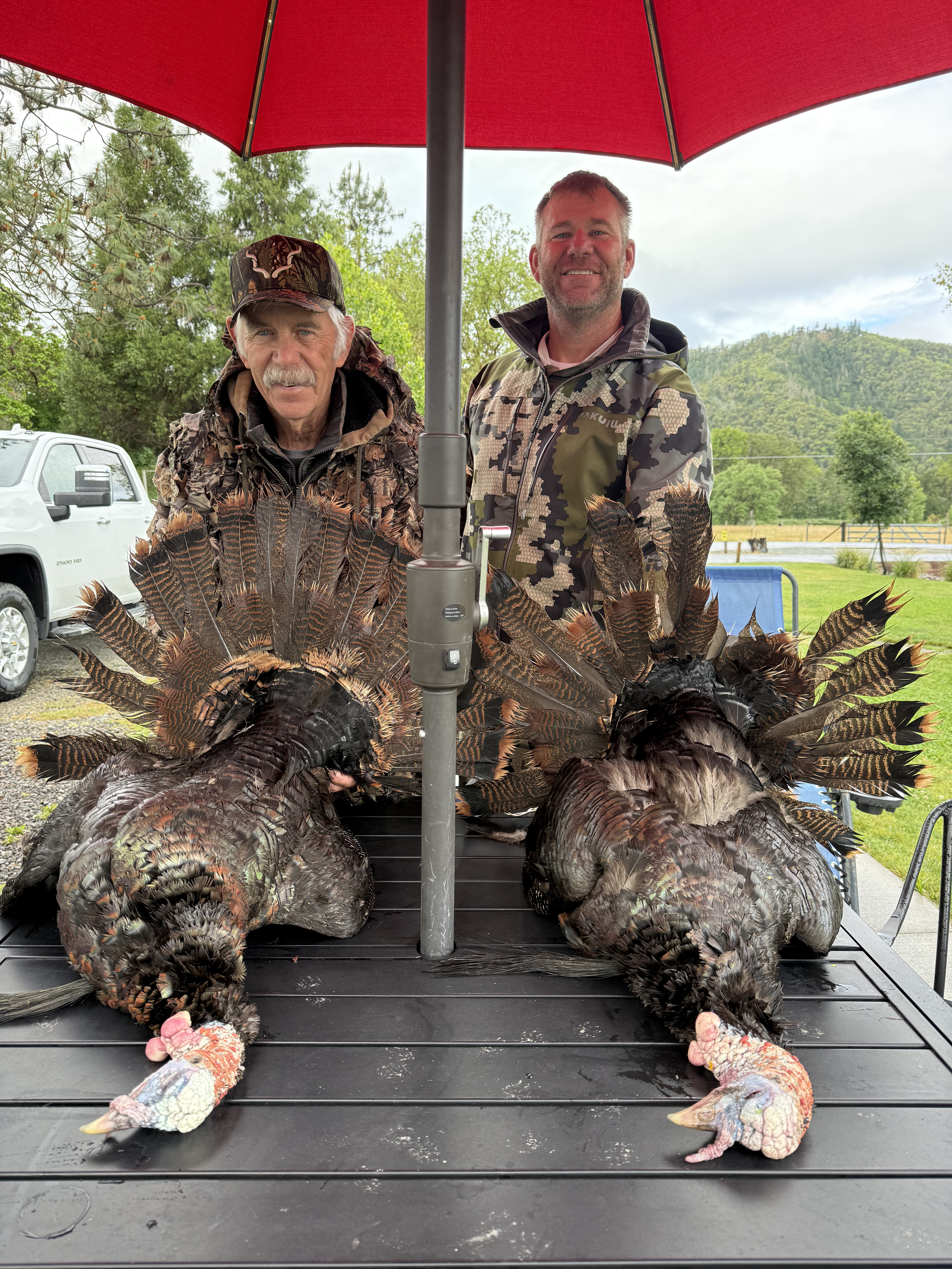 Two hunters with harvested turkeys in Southwest Oregon